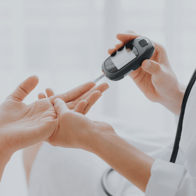 Healthcare practitioner using an instrument to test a patient's blood sugar