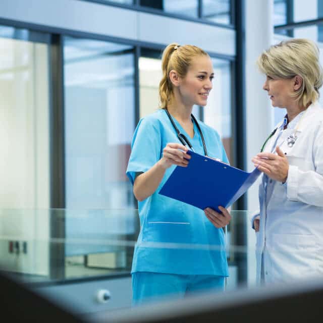 A younger female doctor and an older female doctor having a conversation