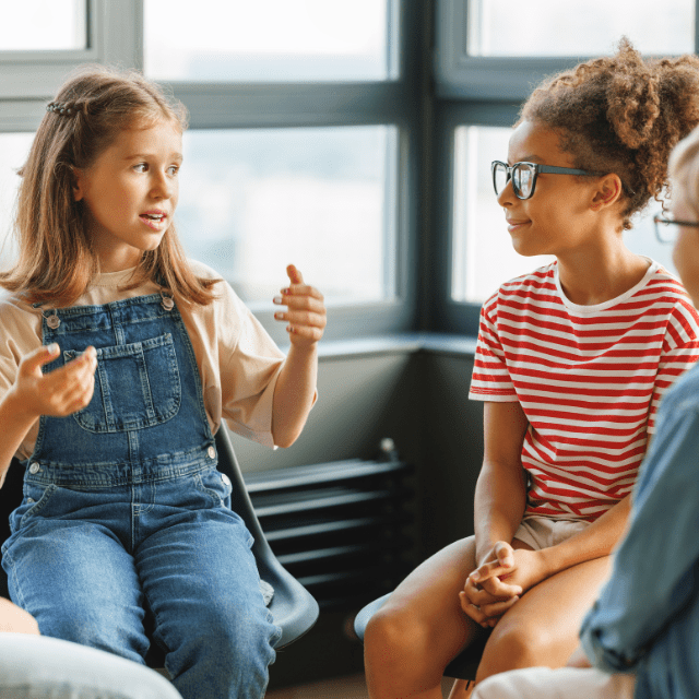 Multiple children sitting and having a discussion