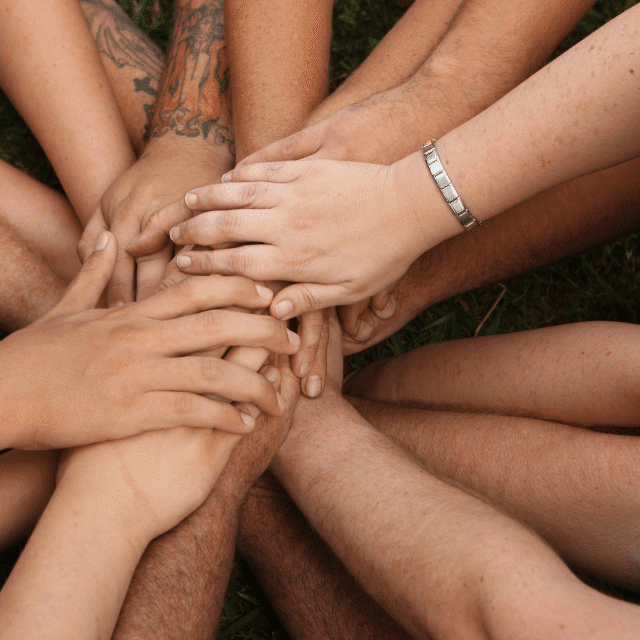 Many hands together in circle