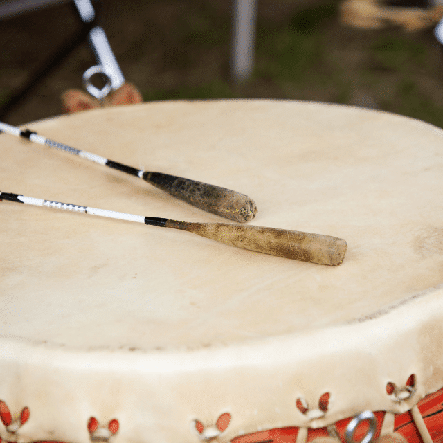 Indigenous big drum with two drumsticks sitting on top