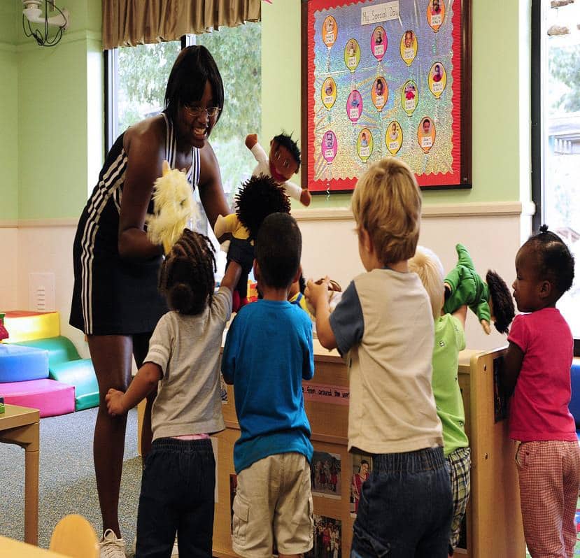 A babysitter entertains a group of children