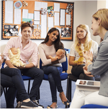 A group of babysitters sitting in a circle.