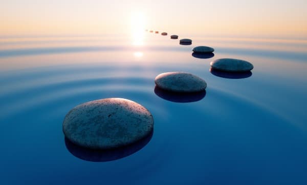 Round rocks on smooth water