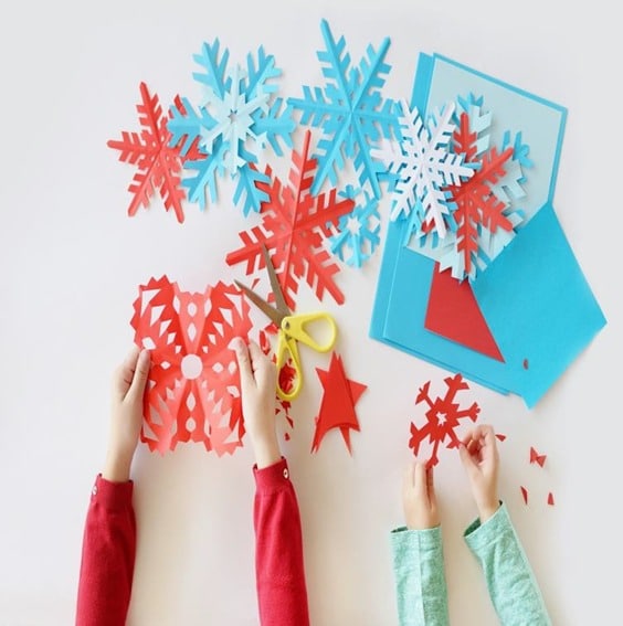 Children's hands completing arts and crafts.
