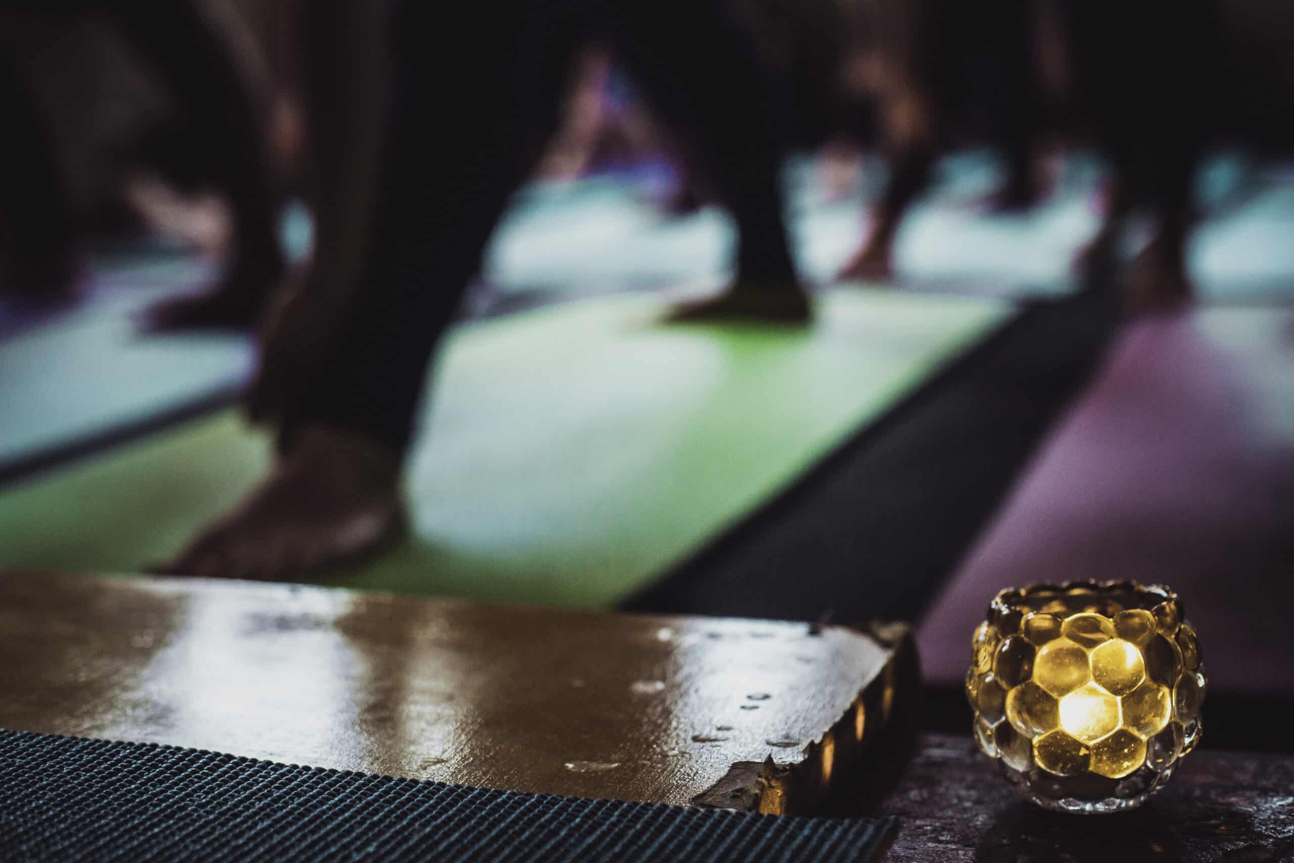 Out of focus photo of dimly lit yoga class