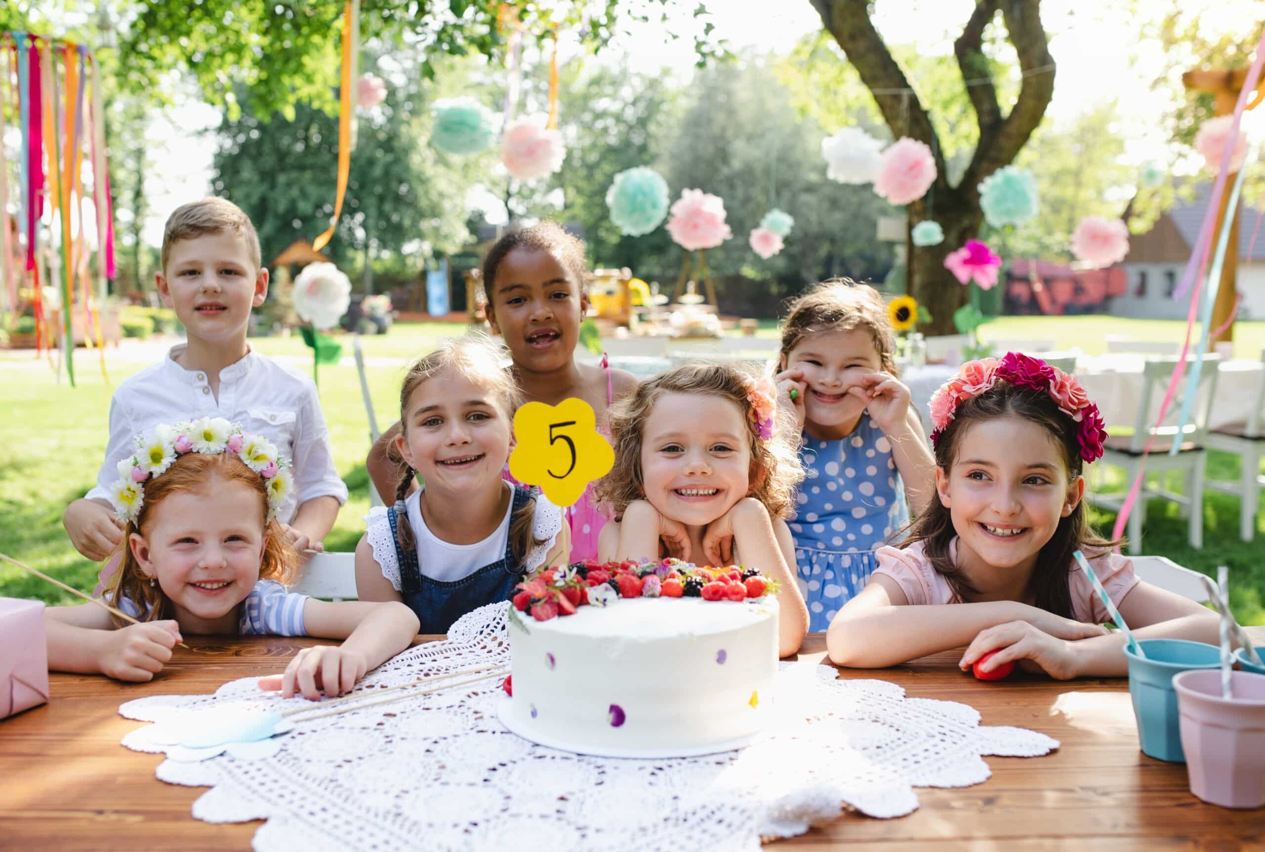 Kids birthday party outdoors in garden in summer.