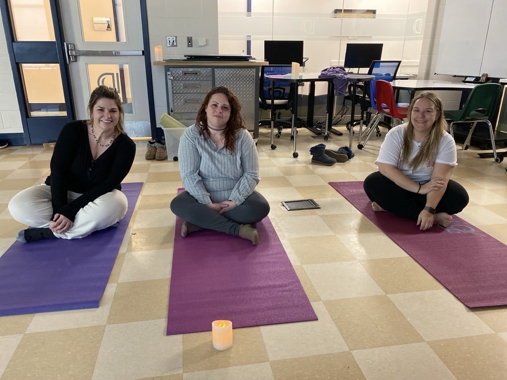 Three parents participate in Yoga during Parent Coffee Break