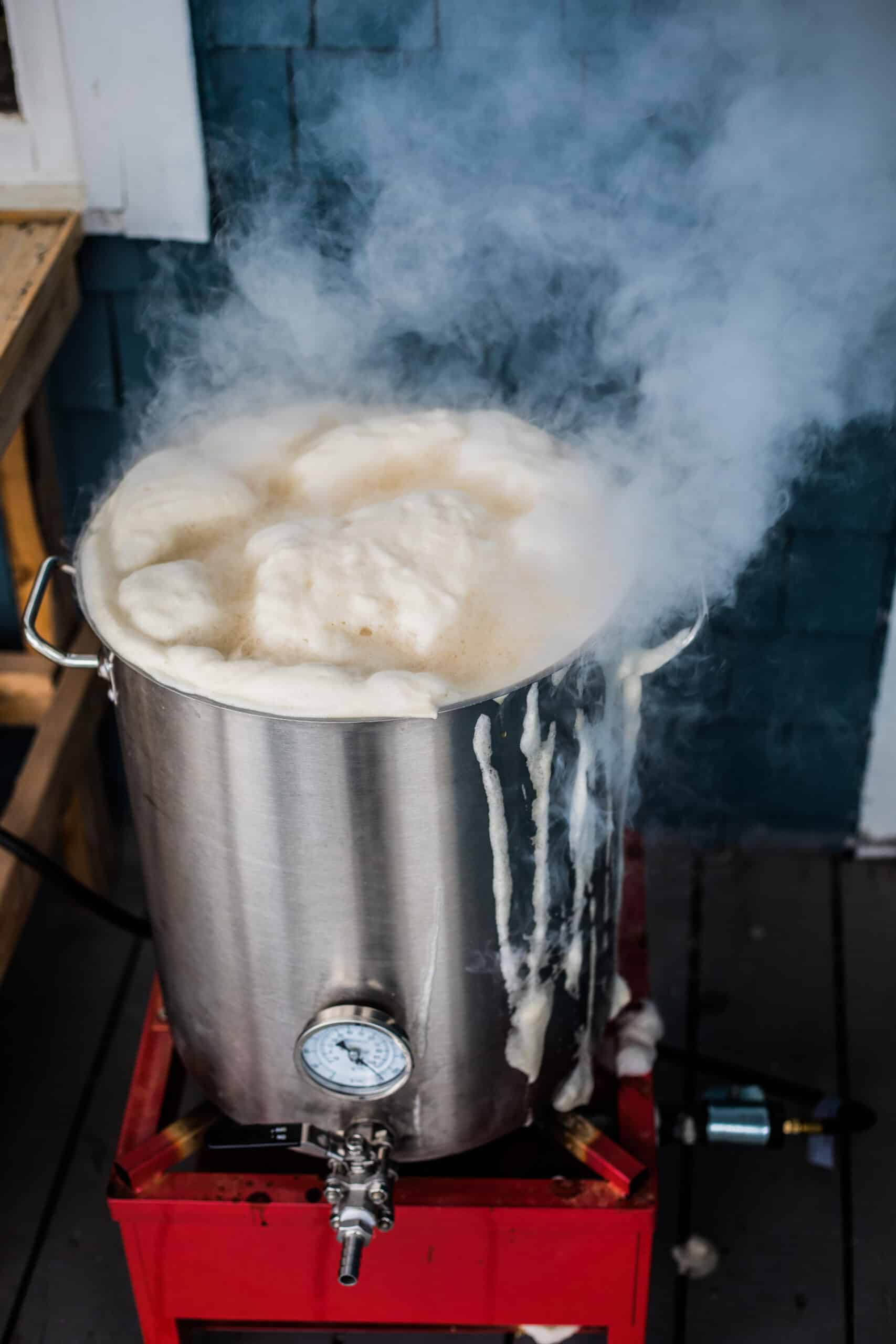 Boil Over or a Homebrewing Hot Break and lot of Protein Froth on to of the Boil Kettle Warming up to a Boiling Temperature.